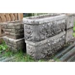 A pair of reclaimed garden planters of rectangular form with canted corners, lions mask and