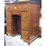 An Edwardian mahogany and oak lined kneehole dressing table in a Georgian manner, the central