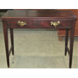 An oak side table fitted with two frieze drawers on square tapered legs