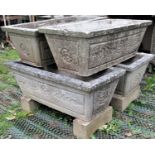 A set of four reclaimed garden planters of rectangular and tapered form with foliate detail, 82cm