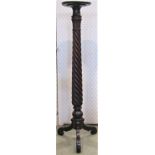 An 18th century mahogany torchere on tapering spiral twist column on tripod base, 127 cm in height