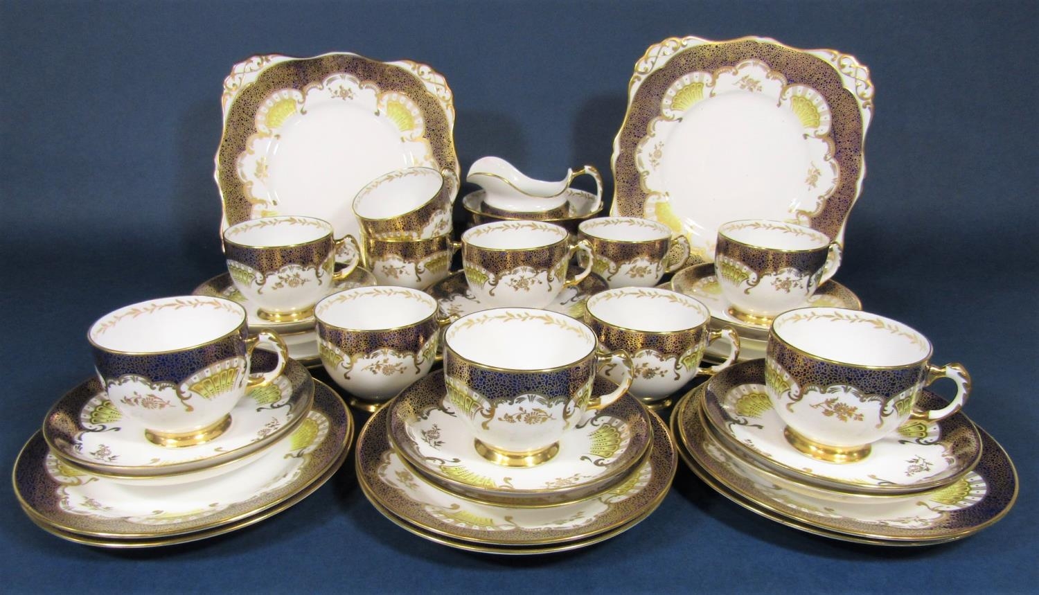 A collection of Tuscan china teawares with blue and gilt decoration comprising pair of cake