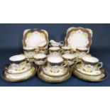 A collection of Tuscan china teawares with blue and gilt decoration comprising pair of cake