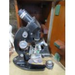 A Vintage Cooke Troughton & Simms black lacquered binocular microscope within a wooden case