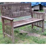 A contemporary weathered hardwood two seat garden bench with slatted seat, back and arms, (af) 126cm