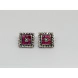 Pair of 18ct white gold ruby and diamond cluster earrings of square form, 1.2cm, 4.7g