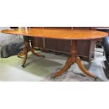 A reproduction Georgian style yew wood veneer twin pedestal dining table with two additional leaves,