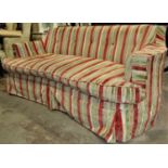 A low backed three seat sofa with shaped outline, alternating striped upholstery, raised on five