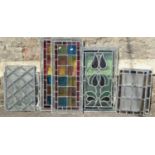 Eight small reclaimed leaded and stained glass panels of varying size and design