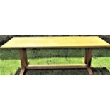 An Arts and Crafts light oak refectory table ,the rectangular top raised on square cut supports