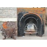 A small reclaimed cast iron fire basket, with scrolling dragon, shell and lattice detail, 54cm (full