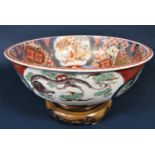 A 19th century imari bowl with painted character to the interior of an immortal amongst clouds,
