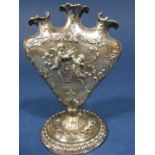 Victorian import silver three stem vase/hat pin holder, the bowl embossed with playful cherubs, upon