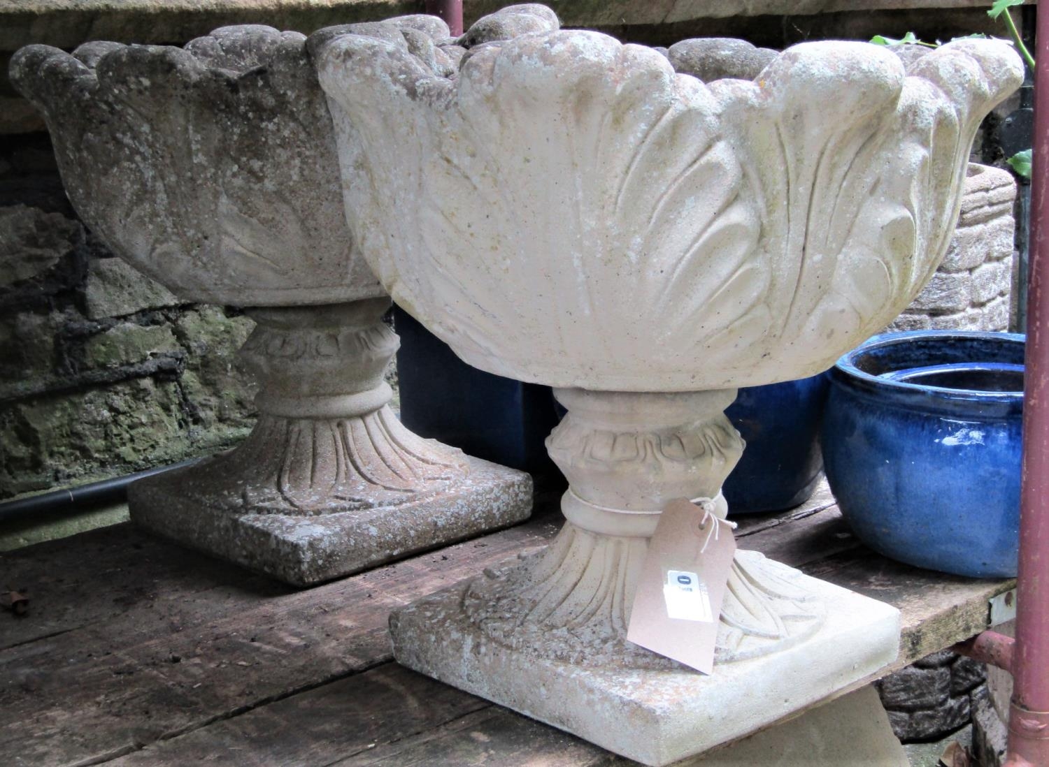 A pair of reclaimed garden planters with circular cabbage leaf bowls, raised on foliate socles