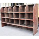 A vintage pitched pine pigeon holed cabinet with open segmented shelves, 164 cm wide x 34 cm deep