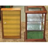 A small mahogany countertop display cabinet enclosed by three glazed and one mirrored panel side,