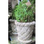 A pair of reclaimed garden planters in the form of lattice baskets, with rope twist rims, containing