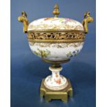 A 19th century continental vase and cover with pierced and scrolling gilt metal mounts and with