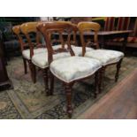 A set of six Victorian style mahogany dining chairs with upholstered seats on turned forelegs