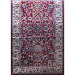Belgian wool runner with scrolled foliate decoration upon a deep red ground, 250 x 85cm