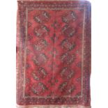 Good antique Turkoman rug with Bokara decoration, upon a brick red ground, 165 x 105cm