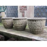 Three small reclaimed garden planters of circular tapered form with relief detail, 30 cm in diameter
