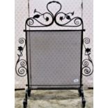 A good quality Victorian wrought iron firescreen with floral and scrolled detail