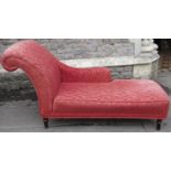 A small contemporary chaise longue with scrolled end on turned supports, 160cm long approx
