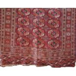 Good antique Turkoman rug with Bokara decoration upon a red ground, 140 x 105cm