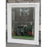 A rectangular wall mirror with bevelled edge plate within a moulded frame with applied foliage