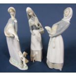 Two Lladro figures of a girl holding a lamb and a woman with bread basket and puppy, together with a