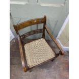 A single Regency elbow chair with original painted and stencilled detail, with pierced splat, cane