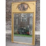Georgian style wall mirror with gilt frame and applied mouldings enclosing an oval Wattauesque style
