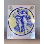 A continental faience glazed terracotta plaque tile decorated with two cherubs holding a crested