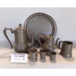 A large collection of antique and later pewter comprising four chargers, various teawares, tankards,