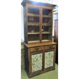 A Victorian scrubbed pine cottage cupboard, the lower section enclosed by panelled doors and two