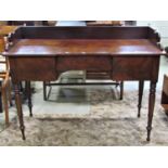 A late Regency mahogany dressing table fitted with three drawers and three quarter gallery, raised