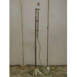 An old English style polished brass lamp standard with adjustable column on a spun base