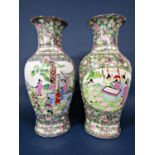 A pair of large modern oriental polychrome vases with male and female character decoration amongst