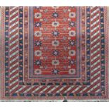 Unusual probably Turkish rug with relief pile of geometric flowers upon an orange ground, 190 x