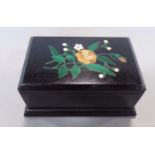 A small 19th century black slate two divisional stamp box, the top inlaid showing a floral spray,