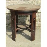 A Arts and Crafts oak occasional table with circular top raised on four pierced supports 75cm in