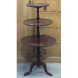 An Edwardian three tier graduated dumb waiter in the Georgian manner with turned columns and