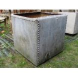 A reclaimed galvanised steel water tank of square form with pot riveted seams, 2ft square