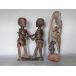 Tribal Interest - Pair of early 20th century Tanzanian marriage puppets on later stand, 37cm high,