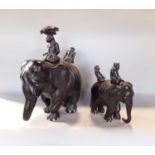Tribal Interest - good quality graduated pair of carved elephants, each with two figures riding upon
