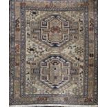 Unusual Sumak type rug with twin medallion decoration upon a pale ground, 100 x 85cm