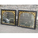 A pair of wall mirrors of rectangular form with stepped and moulded ebonised frames enclosing arched