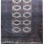 Unusual Turkoman Bokara design rug with typical geometric decoration upon a washed pink ground,