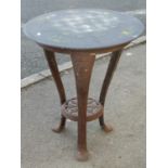 A small Victorian cast iron occasional table with three swept supports united by a pierced